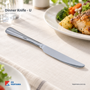 Dinner Knife U shown in a restaurant dining setting; food and other tableware are styling props